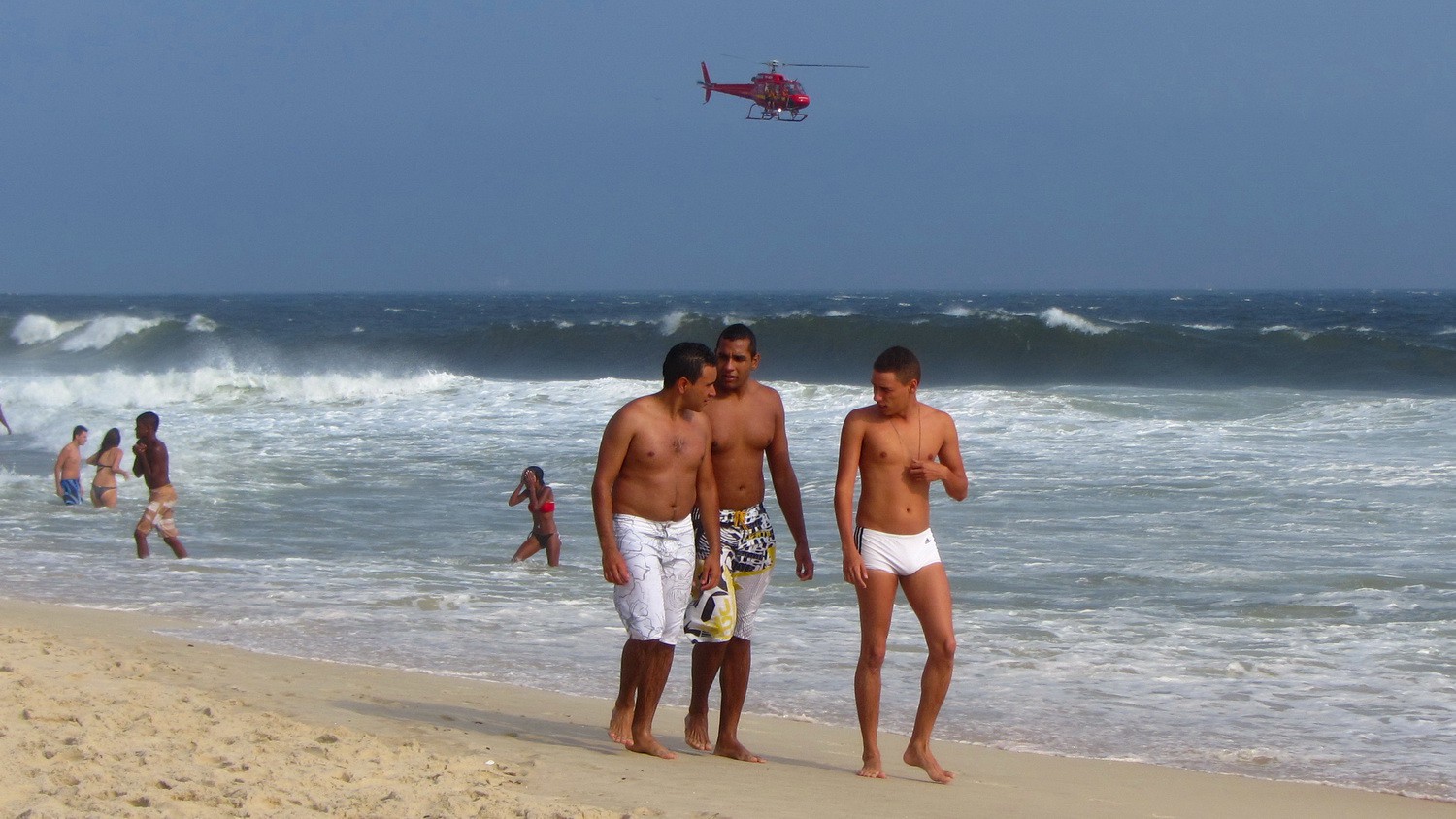 Handsome guys with helicopter looking for surfers in distress